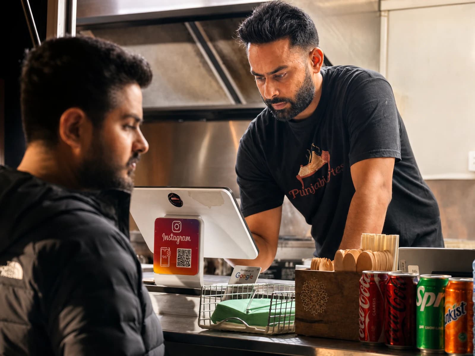 Punjabi Bytes owner Satinder Singh serving a customer from the Woodridge food trailer
