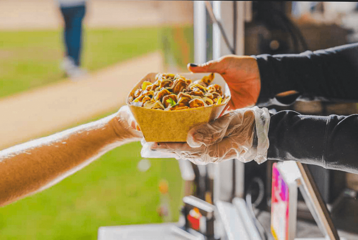 A Punjabi Bytes order being handed to a customer at the food trailer