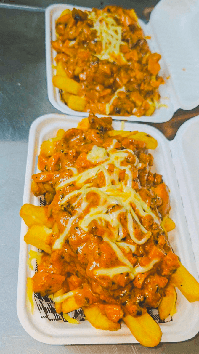 Two serves of Punjabi Bytes loaded fries topped with curry and cheese