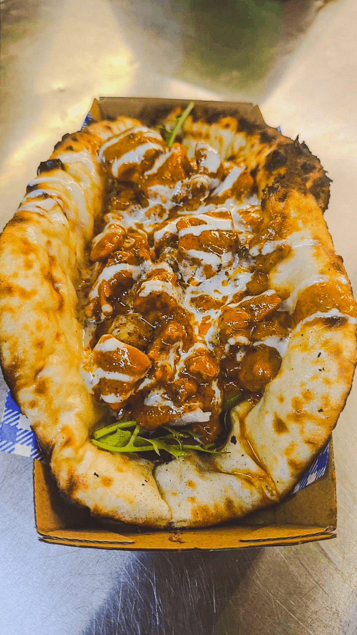 A cheesy naan taco filled with Punjabi curry from the Punjabi Bytes trailer