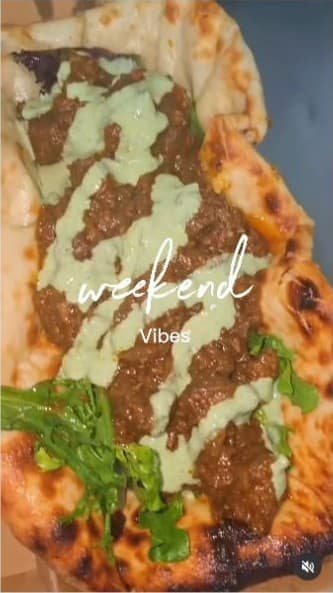 Punjabi Bytes Instagram reel showing a curry-loaded naan